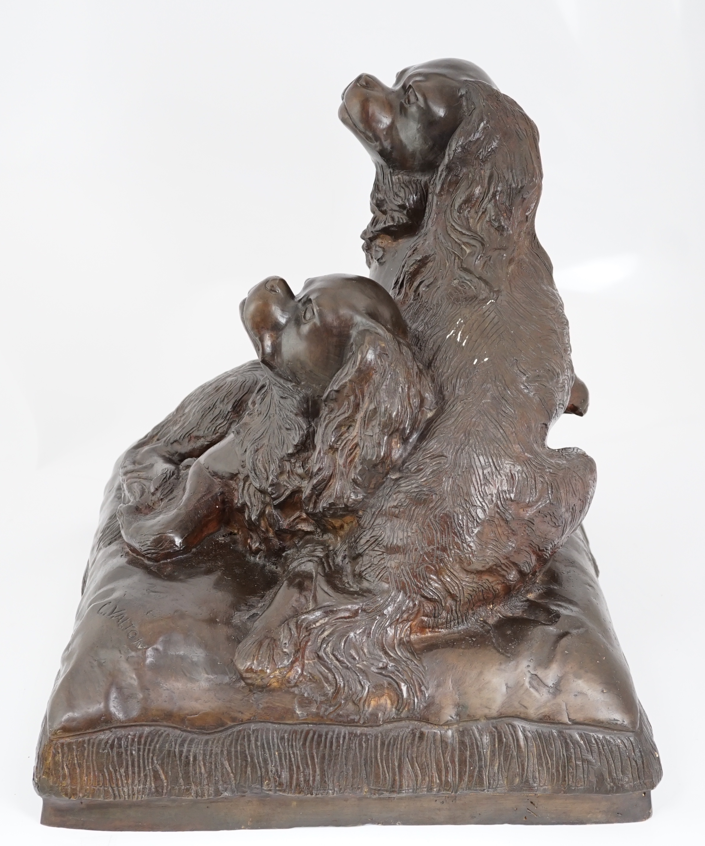 After Charles Valton (French, 1851-1819), a bronze group of two King Charles spaniels seated upon a cushion, 46cm wide, 42cm high